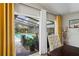 View through sliding glass doors to outdoor pool and lanai with screened enclosure at 3113 Chamblee Ln, Clearwater, FL 33759