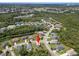 An aerial view of a home nestled among lush greenery in a well-planned community at 3115 Gina Ct, Holiday, FL 34691