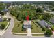 Aerial view of the property featuring a two-car garage and mature landscaping at 3115 Gina Ct, Holiday, FL 34691