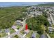 Aerial view of the property located near the water with green landscaping at 3115 Gina Ct, Holiday, FL 34691