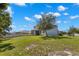 Rear view of the property with a green lawn and white fencing at 3115 Gina Ct, Holiday, FL 34691