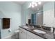 Bathroom features a double sink vanity with granite countertop and a shower and tub combo at 3115 Gina Ct, Holiday, FL 34691