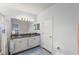 Bright bathroom featuring dual sinks, granite counters, ample storage, and a private toilet area at 3115 Gina Ct, Holiday, FL 34691