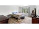 Bright bedroom featuring wood floors, neutral decor, soft textures, and a large window for natural light at 3115 Gina Ct, Holiday, FL 34691