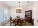 Elegant dining room featuring decorative chandelier, traditional furniture, and ample natural light at 3115 Gina Ct, Holiday, FL 34691