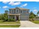 Charming two-story home with manicured lawn, mature landscaping, and a two-car garage at 3115 Gina Ct, Holiday, FL 34691