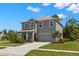 Charming two-story home with manicured lawn, mature landscaping, and a two-car garage at 3115 Gina Ct, Holiday, FL 34691