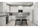 Bright kitchen featuring white cabinets, granite counters, stainless appliances, and eat-in island at 3115 Gina Ct, Holiday, FL 34691