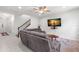 Cozy living room with tiled floor, neutral paint, ceiling fan, and staircase at 3115 Gina Ct, Holiday, FL 34691