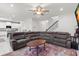 Spacious living room adjacent to kitchen featuring a sectional sofa and bright neutral decor at 3115 Gina Ct, Holiday, FL 34691