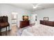 Comfortable main bedroom featuring wood floors, neutral decor, and a bathroom entrance at 3115 Gina Ct, Holiday, FL 34691