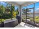 View of the enclosed porch and backyard at 3115 Gina Ct, Holiday, FL 34691