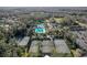 Aerial view of a community, highlighting the pool, tennis courts, playground, and green spaces at 3241 Evening Breeze Loop, Wesley Chapel, FL 33544