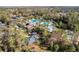 Overhead view of community pool, play area, and clubhouse nestled amongst the trees at 3241 Evening Breeze Loop, Wesley Chapel, FL 33544