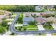 Aerial view of a two-story home with an attached garage and well-maintained landscaping in a neighborhood at 3241 Evening Breeze Loop, Wesley Chapel, FL 33544