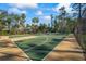 Community outdoor basketball court featuring well-maintained courts, trees, and fencing at 3241 Evening Breeze Loop, Wesley Chapel, FL 33544