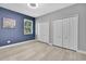 Comfortable bedroom featuring two closets, wood-look floors, neutral walls and a window with blinds at 3241 Evening Breeze Loop, Wesley Chapel, FL 33544