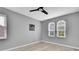 Empty bedroom with neutral walls, two windows with wood blinds, and light laminate flooring at 3241 Evening Breeze Loop, Wesley Chapel, FL 33544