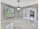 Elegant dining room with white floors, a chandelier, and a large window at 3241 Evening Breeze Loop, Wesley Chapel, FL 33544