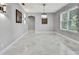 Formal dining room with a stylish chandelier and ample natural light at 3241 Evening Breeze Loop, Wesley Chapel, FL 33544