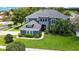 Attractive two-story home with a well-kept lawn, black front door, and mature landscaping at 3241 Evening Breeze Loop, Wesley Chapel, FL 33544
