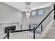 Bright two-story foyer with a chandelier, pool view, and stairs with black handrail at 3241 Evening Breeze Loop, Wesley Chapel, FL 33544
