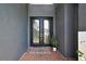 Elegant double front door with decorative glass panels and brick entryway at 3241 Evening Breeze Loop, Wesley Chapel, FL 33544