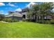Landscaped front yard featuring well-maintained lawn and a two-story home with a charming exterior at 3241 Evening Breeze Loop, Wesley Chapel, FL 33544