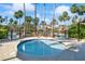 Community hot tub next to the pool with chairs and palm trees at 3241 Evening Breeze Loop, Wesley Chapel, FL 33544