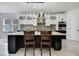 Modern kitchen with a large island, stainless steel appliances, and sleek white cabinets at 3241 Evening Breeze Loop, Wesley Chapel, FL 33544