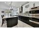 Modern kitchen with stainless steel appliances, black cabinets, and sleek countertops offers a contemporary cooking space at 3241 Evening Breeze Loop, Wesley Chapel, FL 33544