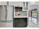 Kitchen area features stainless steel appliances, a microwave, and a view of the pool at 3241 Evening Breeze Loop, Wesley Chapel, FL 33544