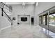Open-concept living area featuring high ceilings, a stone accent wall, and tile flooring at 3241 Evening Breeze Loop, Wesley Chapel, FL 33544