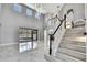 Spacious living room with high ceilings, grand staircase and white tile flooring at 3241 Evening Breeze Loop, Wesley Chapel, FL 33544