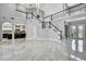 Large living room with tile floors and a staircase to the second floor at 3241 Evening Breeze Loop, Wesley Chapel, FL 33544