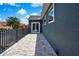 Outdoor balcony with tile flooring, iron railing, and dark blue stucco exterior walls at 3241 Evening Breeze Loop, Wesley Chapel, FL 33544