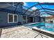 Beautiful backyard pool with screened-in enclosure and a connecting spa, perfect for relaxation at 3241 Evening Breeze Loop, Wesley Chapel, FL 33544