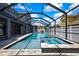 Stunning backyard pool and spa area with a screened enclosure and ample space at 3241 Evening Breeze Loop, Wesley Chapel, FL 33544