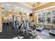 Well-equipped workout room with modern exercise equipment and views of the pool and surrounding area at 3241 Evening Breeze Loop, Wesley Chapel, FL 33544
