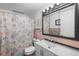 Bathroom with flamingo-themed shower curtain, white vanity, and pink wall tiles at 3260 Gulfview Dr, Hernando Beach, FL 34607