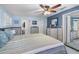 Light-blue bedroom with wood-look wall paneling, beach-themed decor, and ensuite bathroom access at 3260 Gulfview Dr, Hernando Beach, FL 34607