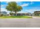 Charming single-story home with a well-kept lawn, lush trees, and a cozy front porch at 3260 Gulfview Dr, Hernando Beach, FL 34607