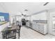 Open kitchen with white cabinetry, stainless appliances, and an adjacent dining area at 3260 Gulfview Dr, Hernando Beach, FL 34607