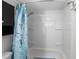 Shower featuring white walls, built-in shelving, and a themed shower curtain at 3260 Gulfview Dr, Hernando Beach, FL 34607