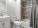 Cozy bathroom featuring a tub with wood-look tile surround, toilet, and modern sink with cabinet at 3323 Fox Hunt Dr, Palm Harbor, FL 34683