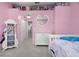 Pink bedroom featuring a heart-shaped mirror, princess-themed dresser, and a display shelf for doll collections at 3323 Fox Hunt Dr, Palm Harbor, FL 34683