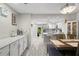 Bright kitchenette featuring white cabinets, marble countertops, and an open view of the kitchen at 3323 Fox Hunt Dr, Palm Harbor, FL 34683