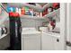 Functional laundry room with washer, dryer, and shelving for storage at 3323 Fox Hunt Dr, Palm Harbor, FL 34683