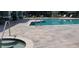 Inviting community pool area with lounging chairs and hot tub at 3493 Kings Rd # 106, Palm Harbor, FL 34685