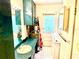 Bathroom including vanity, medicine cabinet, washer and access to the backyard at 3575 Lake Highland Dr, Palm Harbor, FL 34683